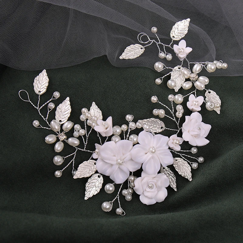 Silver bridal hair vine styled on veil fabric