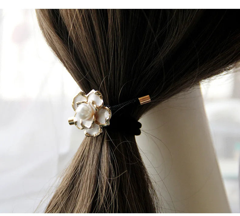 Decorative elastic hair bands for women featuring rhinestones, bows, pearls and alloy charms, styled for ponytails and daily fashion use. 