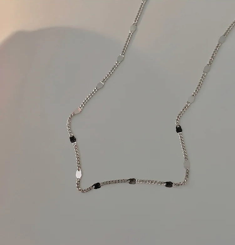 Detail shot of chain links on white surface