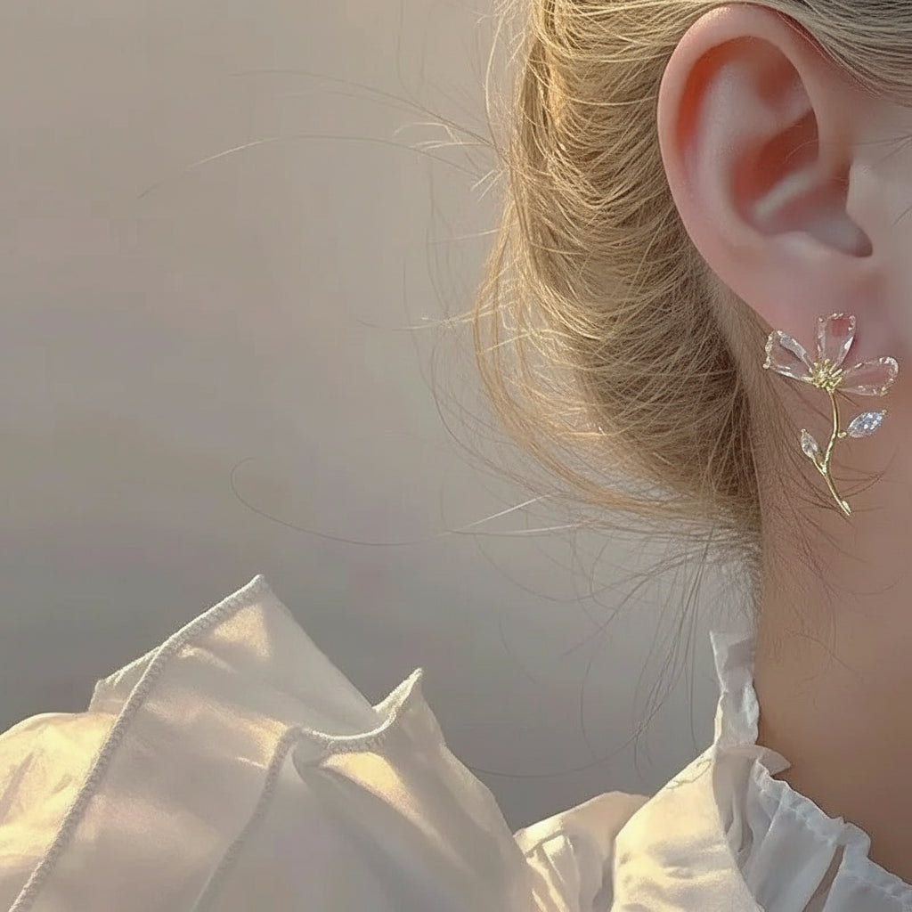 Woman wearing gold CZ branch earrings close-up