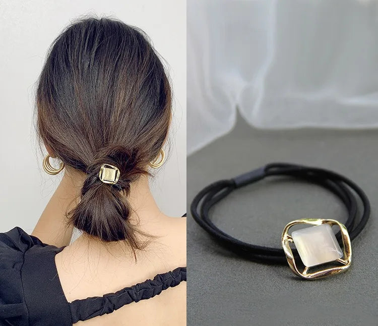 Decorative elastic hair bands for women featuring rhinestones, bows, pearls and alloy charms, styled for ponytails and daily fashion use.