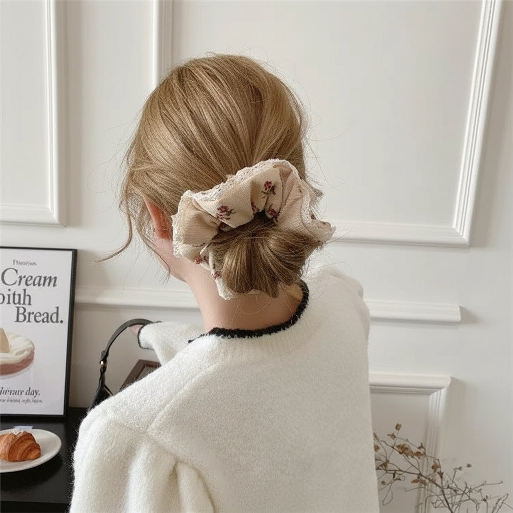 Woman wearing corduroy floral scrunchie styled in a winter ponytail.