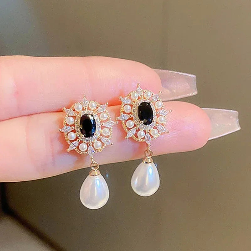 Elegant zircon crystal and simulated pearl stud earrings for women featuring floral and geometric designs, lightweight fashion jewelry.