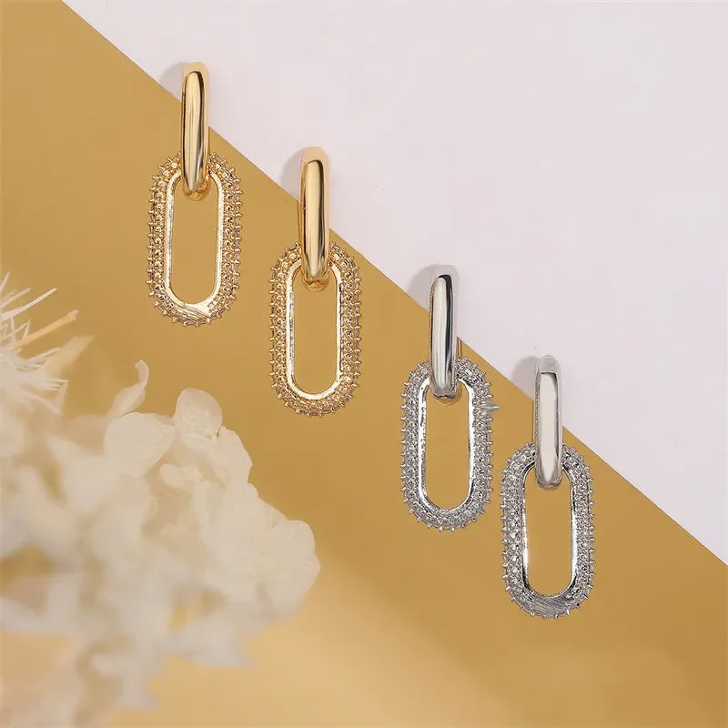 Gold and silver chain-link rhinestone hoop earrings displayed as fashionable geometric accessories.