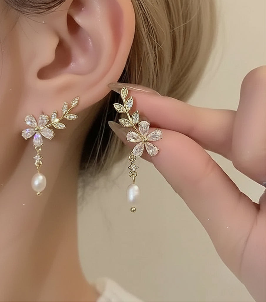 Woman wearing dangling gold crystal branch earrings
