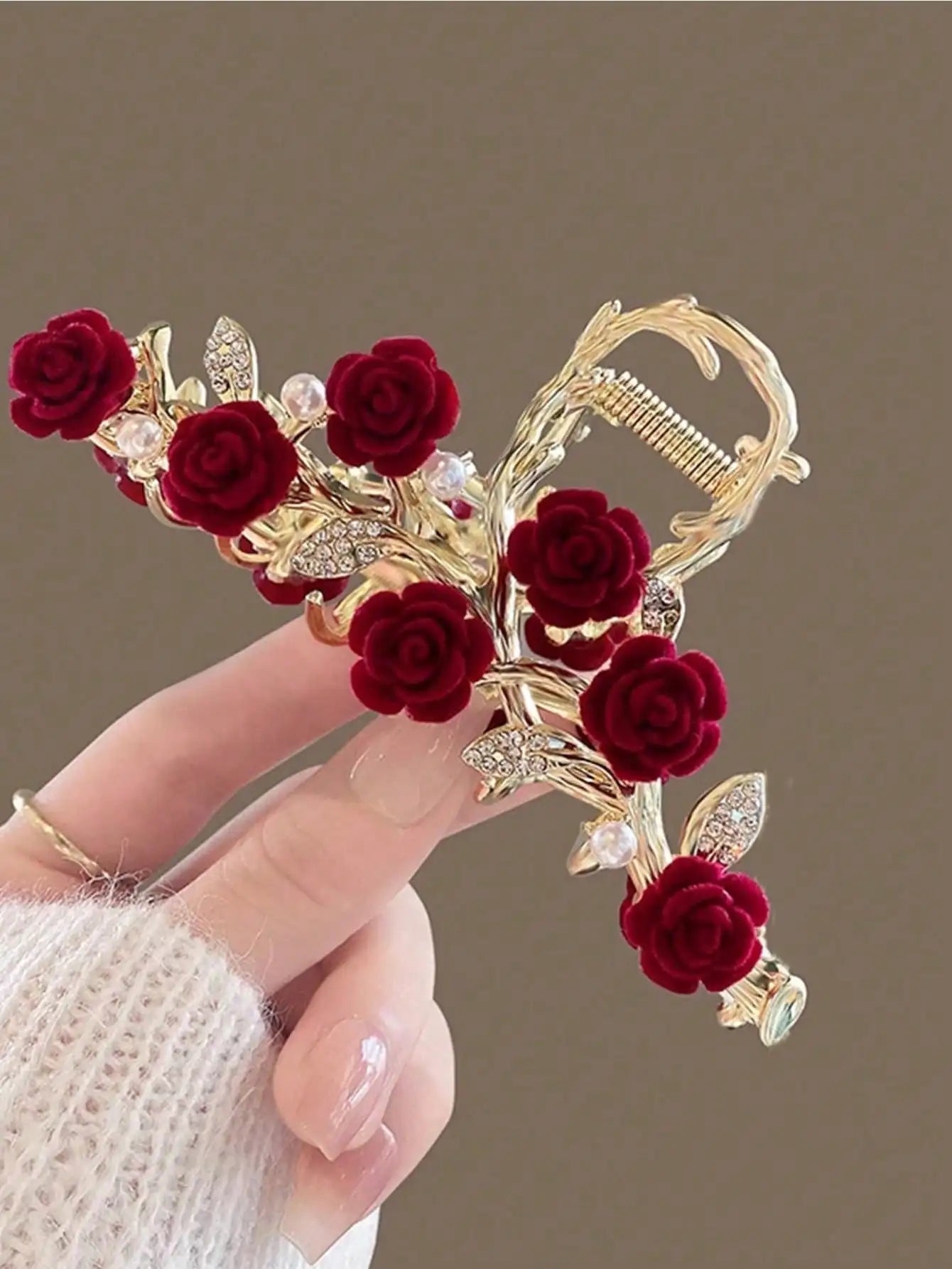 Close-up of alloy rose hair clip showing layered roses and decorative pearl chains.