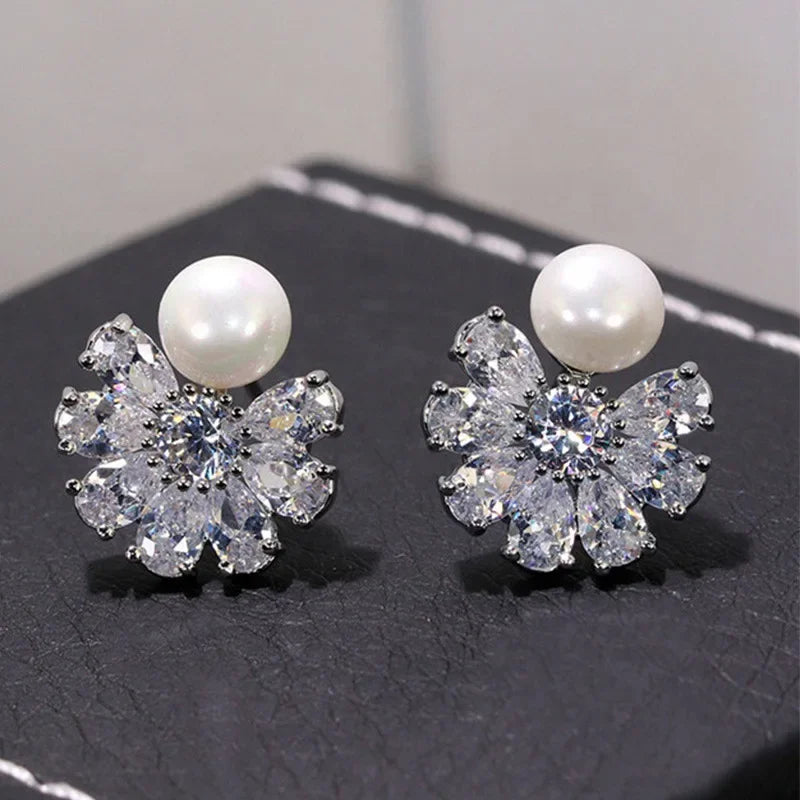 Elegant zircon crystal and simulated pearl stud earrings for women featuring floral and geometric designs, lightweight fashion jewelry.