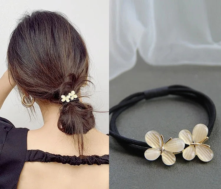 Decorative elastic hair bands for women featuring rhinestones, bows, pearls and alloy charms, styled for ponytails and daily fashion use. 